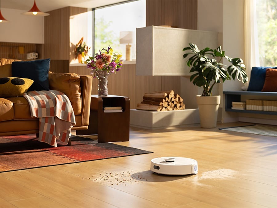 Roborock Q7 TF White odkurza rozsypane zanieczyszczenia na podłodze w przestronnym, stylowym salonie