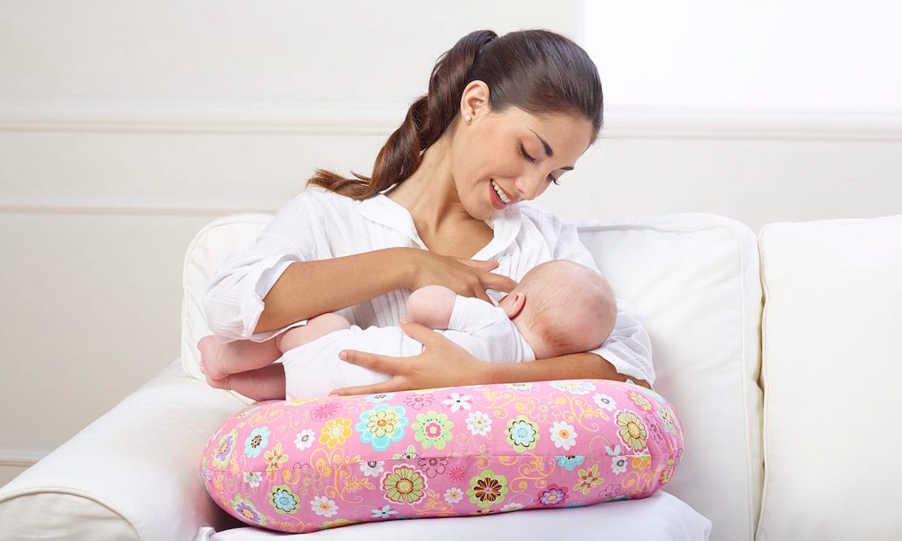 dziecko wygodnie leżące na poduszce Chicco Boppy poszewka French rose